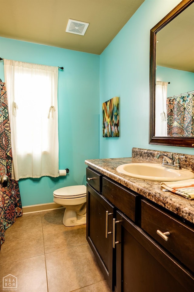 103 Hollis Cv, Bono, AR 72416 - bathroom featuring toilet, tile patterned flooring, vanity, and baseboards