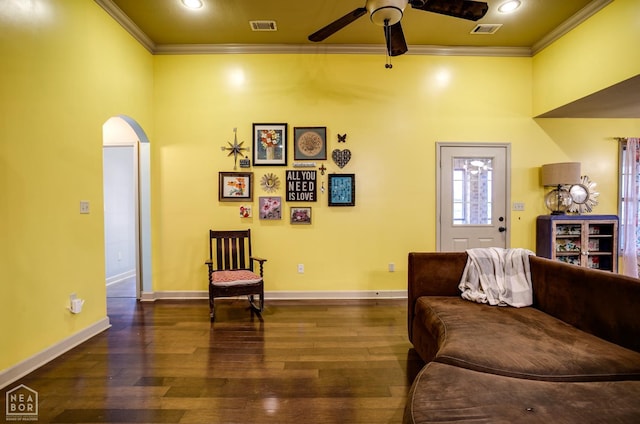 103 Hollis Cv, Bono, AR 72416 - living area featuring crown molding, a ceiling fan, dark wood-style floors, arched walkways, and baseboards
