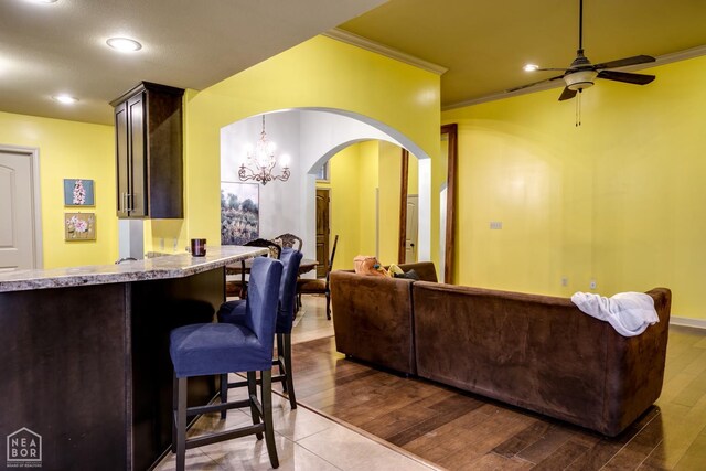 103 Hollis Cv, Bono, AR 72416 - kitchen with crown molding, arched walkways, a ceiling fan, recessed lighting, and a chandelier