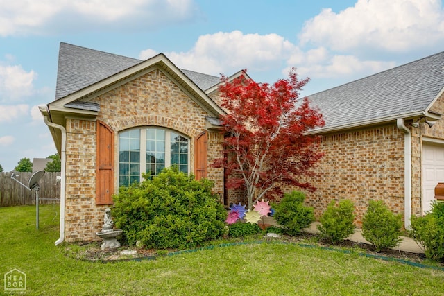 103 Hollis Cv, Bono, AR 72416 - view of front of house with roof with shingles, brick siding, and a garage