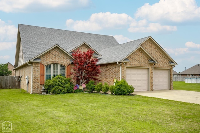 103 Hollis Cv, Bono, AR 72416 - view of front of property with driveway, an attached garage, roof with shingles, and brick siding