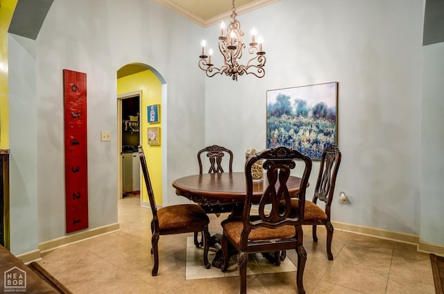 103 Hollis Cv, Bono, AR 72416 - dining space with arched walkways, crown molding, light tile patterned floors, a chandelier, and baseboards