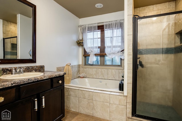 103 Hollis Cv, Bono, AR 72416 - bathroom featuring a shower stall, a garden tub, vanity, and tile patterned flooring