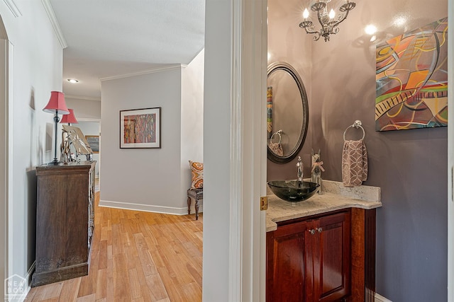 2304 Autumn Dr, Jonesboro, AR 72404 - bathroom with vanity, crown molding, wood finished floors, and a chandelier