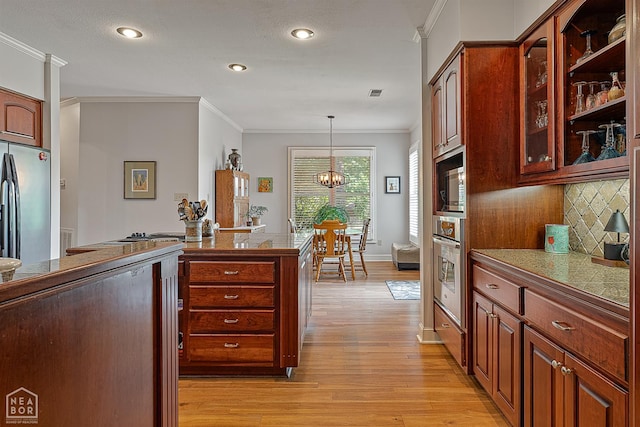 2304 Autumn Dr, Jonesboro, AR 72404 - kitchen with appliances with stainless steel finishes, ornamental molding, light wood-style floors, decorative backsplash, and a chandelier