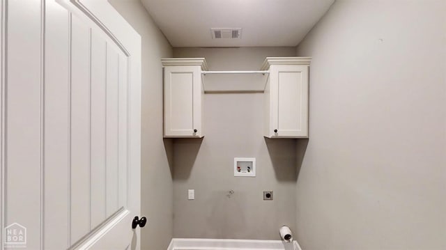 clothes washing area with electric dryer hookup, baseboards, washer hookup, visible vents, and cabinet space