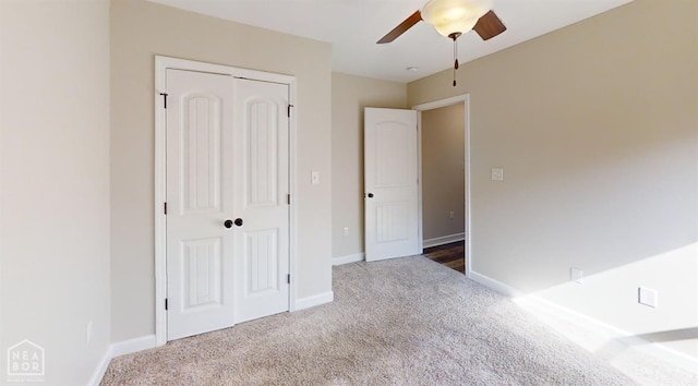 unfurnished bedroom featuring a closet, baseboards, ceiling fan, and carpet