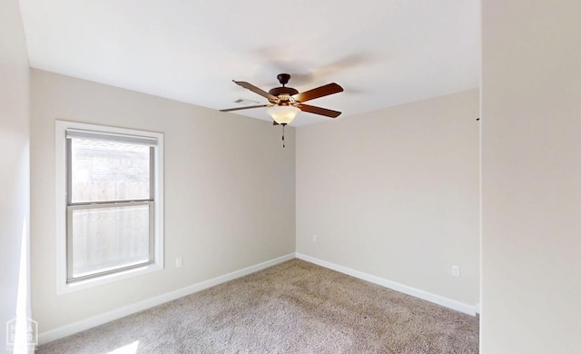 empty room with ceiling fan, carpet flooring, and baseboards