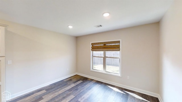 empty room with recessed lighting, visible vents, baseboards, and dark wood-style floors