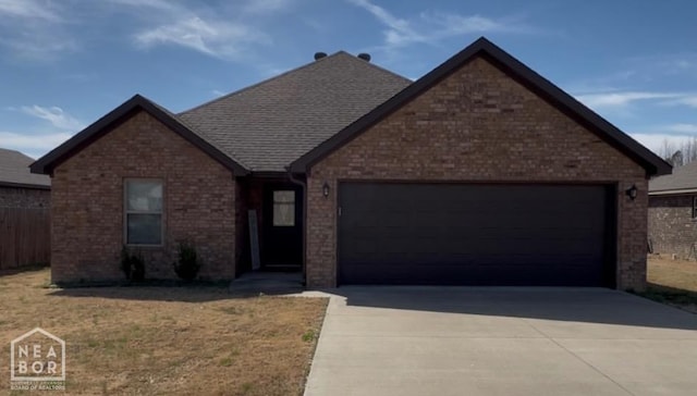 view of front of home with driveway, a front yard, brick siding, a garage, and a shingled roof