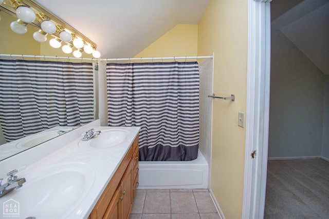 2205 Oak Hollow Ln, Jonesboro, AR 72401 - bathroom with lofted ceiling, double vanity, shower / bath combo with shower curtain, and tile patterned flooring