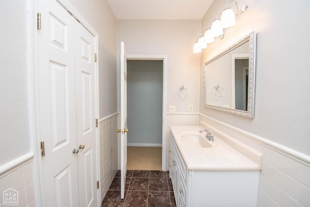 2205 Oak Hollow Ln, Jonesboro, AR 72401 - bathroom featuring vanity, wainscoting, marble finish floors, and tile walls
