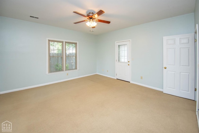 2205 Oak Hollow Ln, Jonesboro, AR 72401 - spare room featuring a ceiling fan, healthy amount of natural light, and light carpet