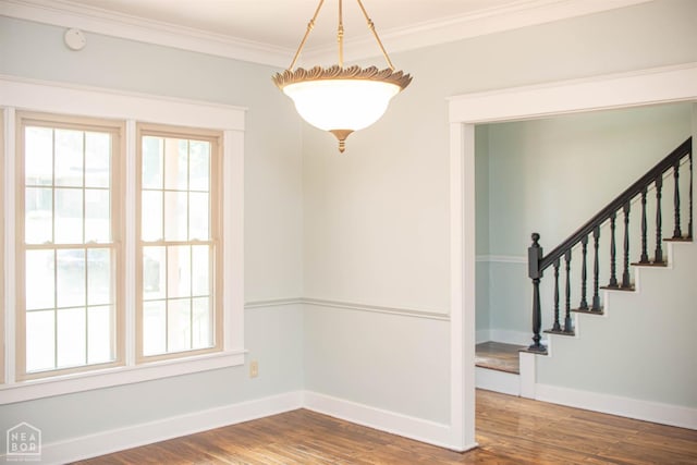 2205 Oak Hollow Ln, Jonesboro, AR 72401 - unfurnished dining area with wood finished floors, ornamental molding, and stairs