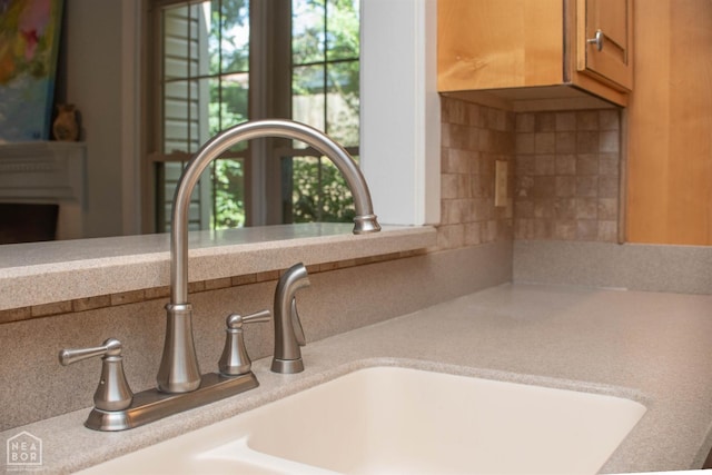 2205 Oak Hollow Ln, Jonesboro, AR 72401 - kitchen view of light countertops, backsplash, and brown cabinetry