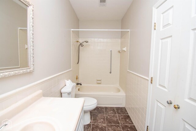 2205 Oak Hollow Ln, Jonesboro, AR 72401 - full bathroom featuring tile walls, vanity, tub / shower combination, and a wainscoted wall