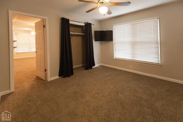 unfurnished bedroom with carpet, a closet, baseboards, and a textured ceiling