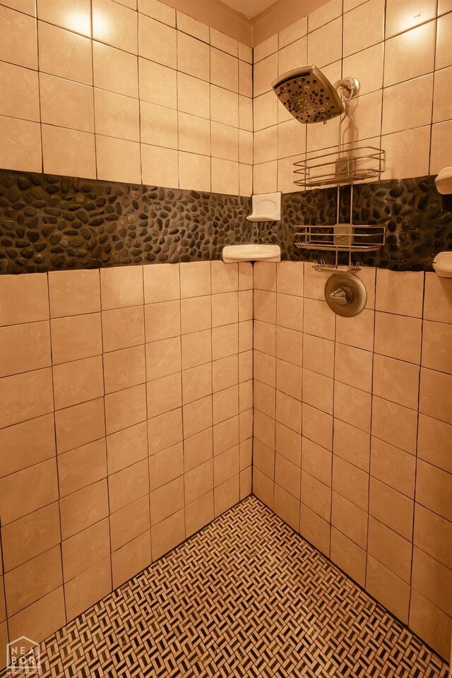 full bath with a tile shower