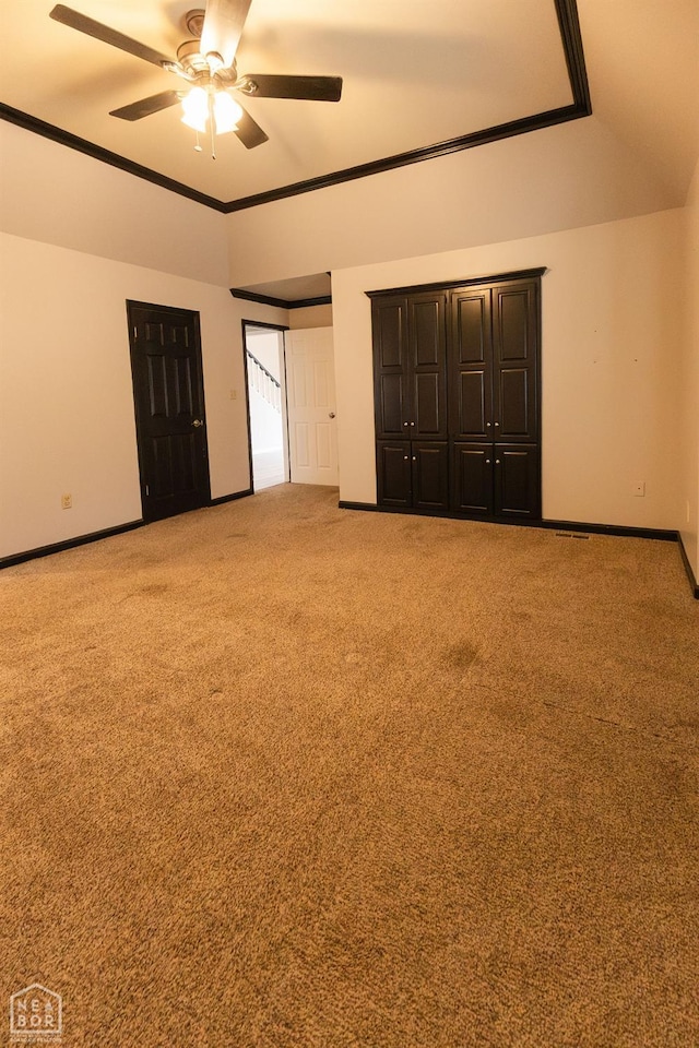 unfurnished bedroom with multiple closets, baseboards, a ceiling fan, and carpet flooring
