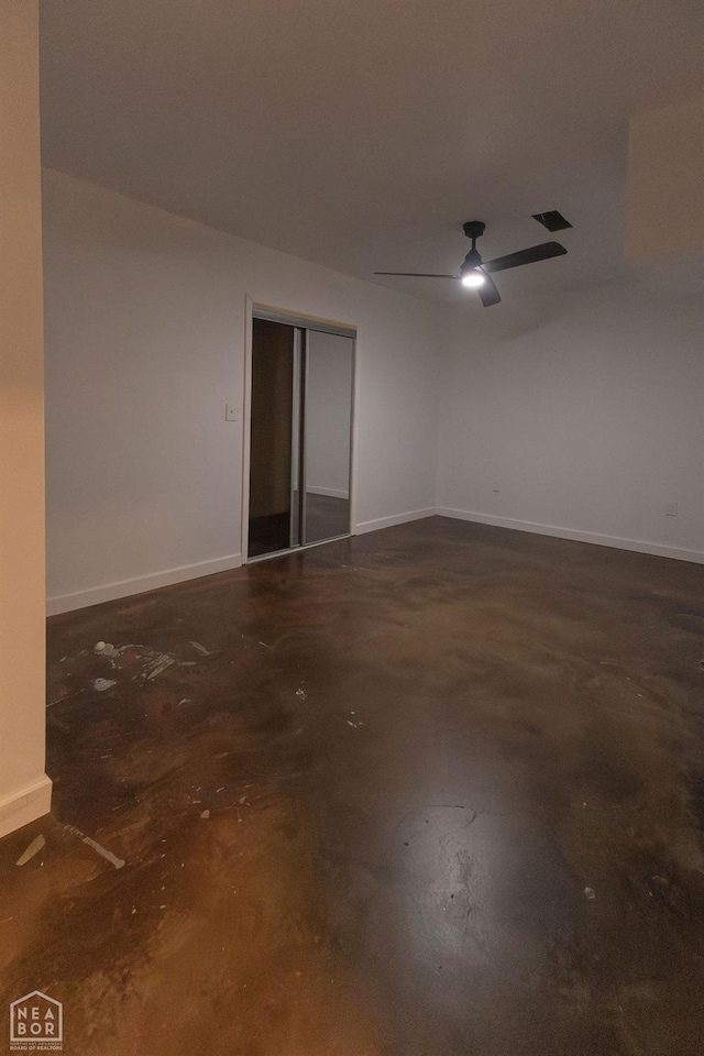 spare room with visible vents, baseboards, concrete flooring, and ceiling fan