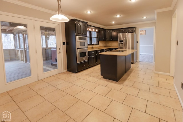 kitchen featuring light tile patterned floors, a sink, light countertops, appliances with stainless steel finishes, and crown molding