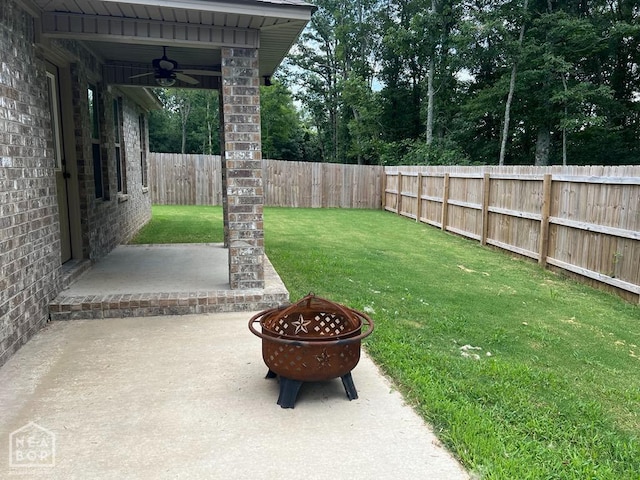 5743 Brookshire Dr, Jonesboro, AR 72401 - fenced backyard with a fire pit, ceiling fan, and a patio