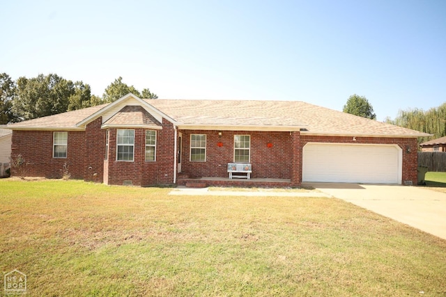 ranch-style house featuring a front yard, an attached garage, concrete driveway, brick siding, and roof with shingles