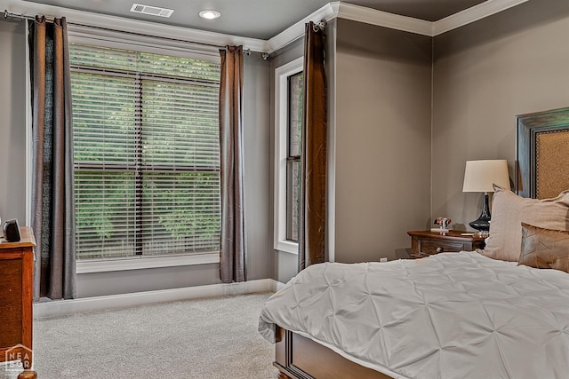 bedroom featuring carpet, crown molding, and baseboards