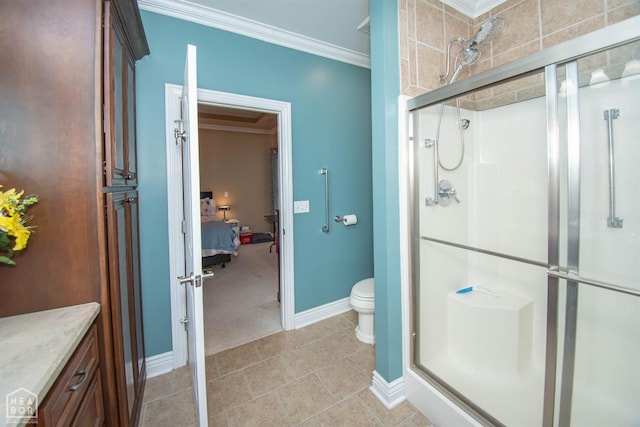 bathroom with baseboards, toilet, crown molding, tile patterned flooring, and a stall shower