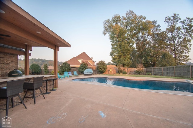 view of pool featuring a patio, outdoor dry bar, a fenced backyard, and a fenced in pool