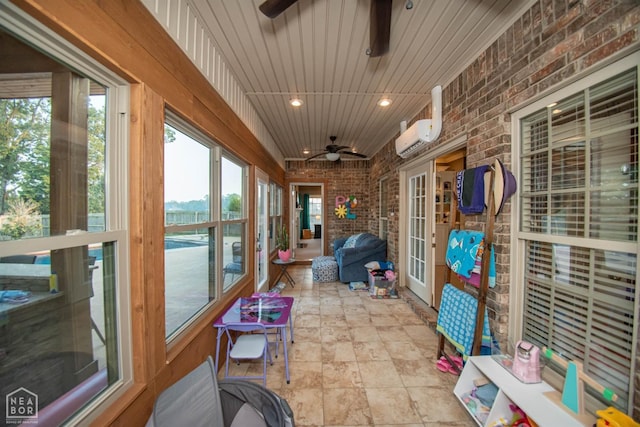 sunroom / solarium featuring a wall mounted air conditioner, french doors, and ceiling fan