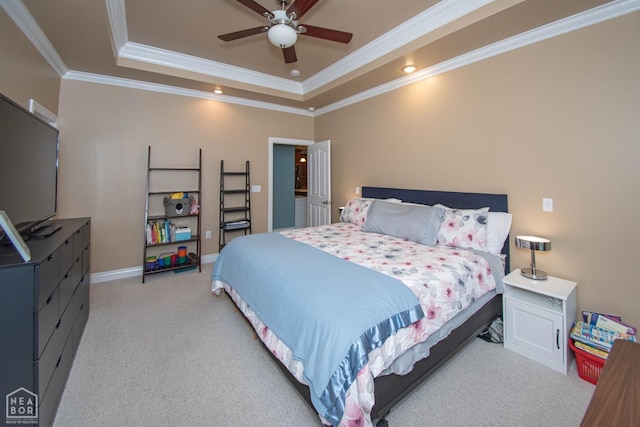 bedroom featuring ceiling fan, ornamental molding, light carpet, a raised ceiling, and baseboards