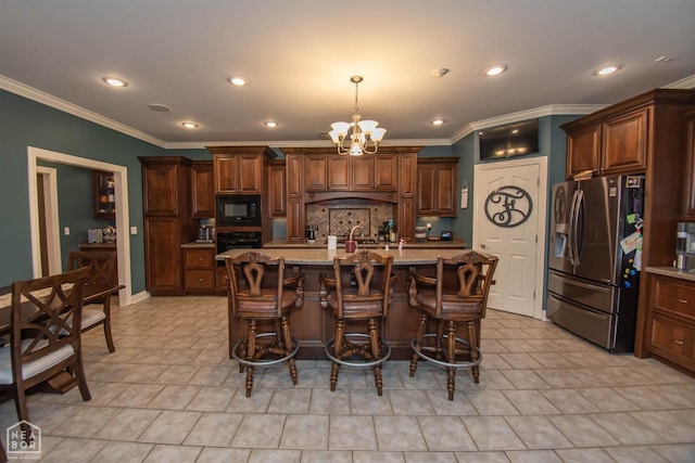 kitchen featuring tasteful backsplash, a notable chandelier, a kitchen bar, and black appliances