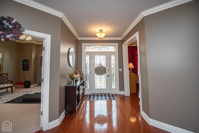 entryway featuring wood finished floors, baseboards, and ornamental molding