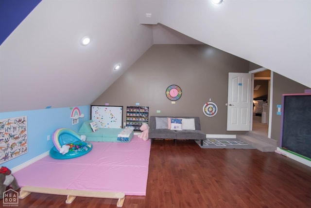 playroom with wood finished floors, baseboards, and vaulted ceiling