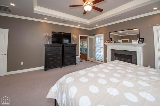 carpeted bedroom with visible vents, baseboards, crown molding, and a raised ceiling