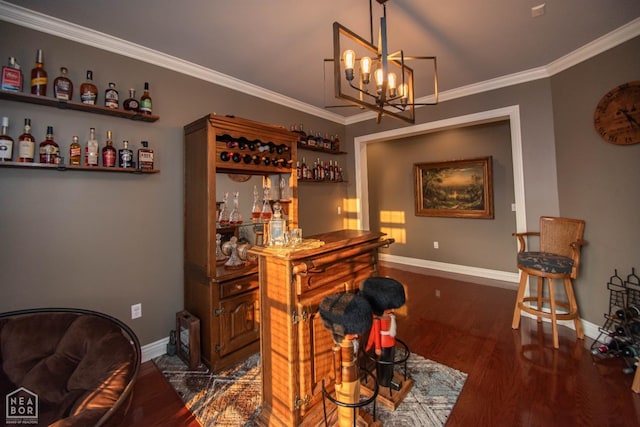 bar with baseboards, a dry bar, a chandelier, crown molding, and wood finished floors