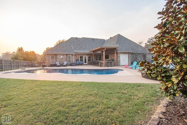 view of swimming pool featuring a patio, a yard, a fenced backyard, and a fenced in pool