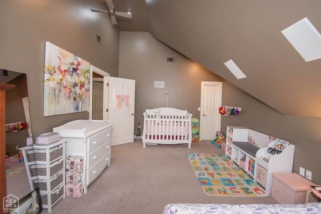bedroom with a skylight, visible vents, and carpet