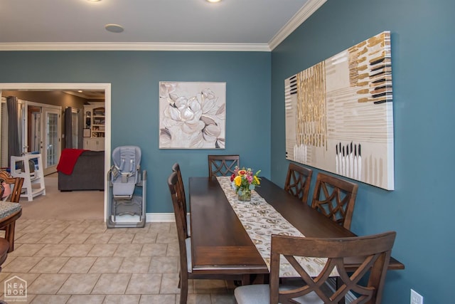 dining room featuring french doors, baseboards, and ornamental molding