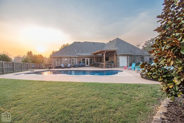 pool at dusk with a fenced in pool, a yard, a patio, and a fenced backyard