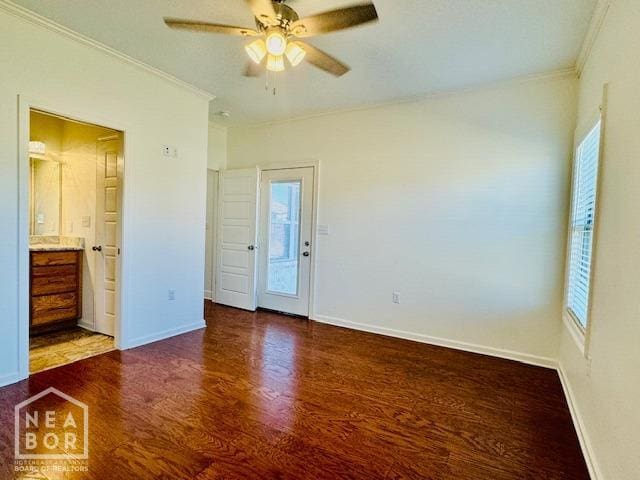 3803 Stone Ridge Dr, Paragould, AR 72450 - unfurnished bedroom with crown molding, multiple windows, dark wood finished floors, baseboards, and ensuite bath