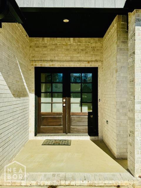3803 Stone Ridge Dr, Paragould, AR 72450 - entrance to property with french doors and brick siding