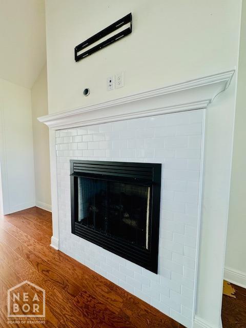 3803 Stone Ridge Dr, Paragould, AR 72450 - detailed view of a fireplace, wood finished floors, and baseboards