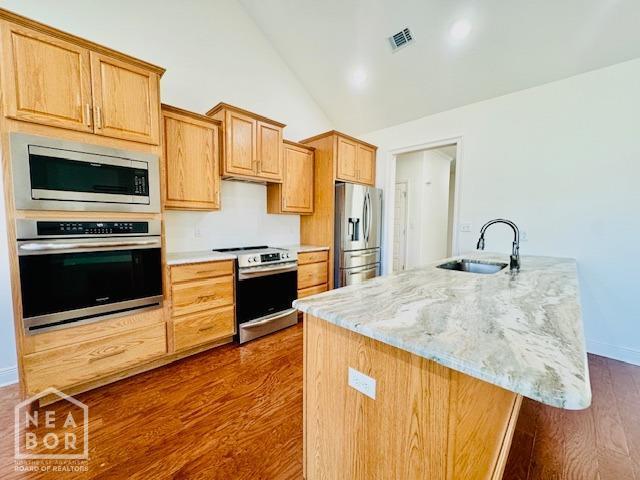 3803 Stone Ridge Dr, Paragould, AR 72450 - kitchen featuring appliances with stainless steel finishes, a sink, dark wood-style floors, light stone countertops, and baseboards