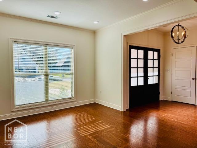 3803 Stone Ridge Dr, Paragould, AR 72450 - entryway featuring ornamental molding, a chandelier, baseboards, french doors, and dark wood-style floors