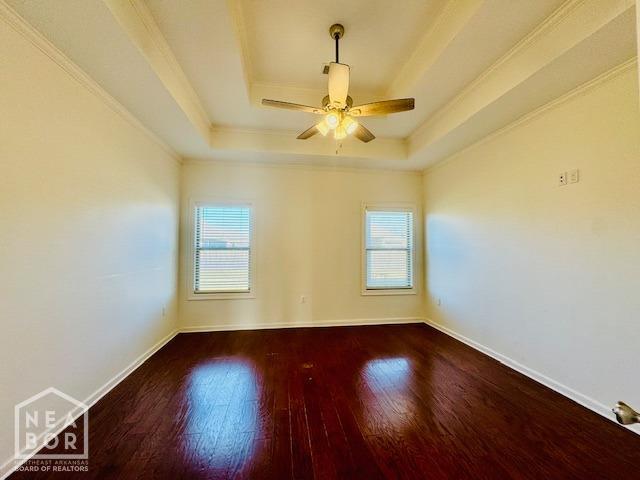 3803 Stone Ridge Dr, Paragould, AR 72450 - empty room with a raised ceiling, wood finished floors, crown molding, baseboards, and ceiling fan