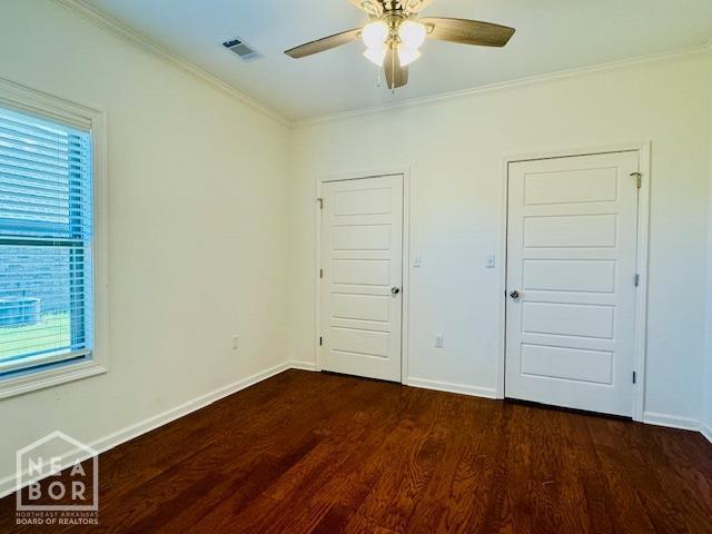 3803 Stone Ridge Dr, Paragould, AR 72450 - unfurnished bedroom featuring dark wood-type flooring, crown molding, baseboards, and a ceiling fan