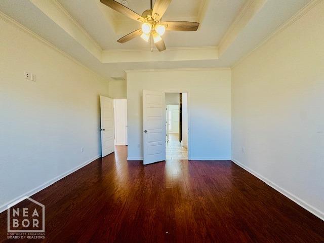 3803 Stone Ridge Dr, Paragould, AR 72450 - unfurnished bedroom with a raised ceiling, wood finished floors, crown molding, baseboards, and ceiling fan