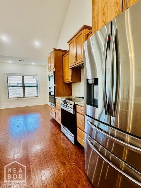 3803 Stone Ridge Dr, Paragould, AR 72450 - kitchen with stainless steel appliances, brown cabinets, dark wood-style floors, light countertops, and recessed lighting